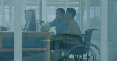 Animation of graphs, diverse woman sitting on wheelchair discussing reports with coworker in office. Digital composite, multiple exposure, business, teamwork, disability and technology concept.