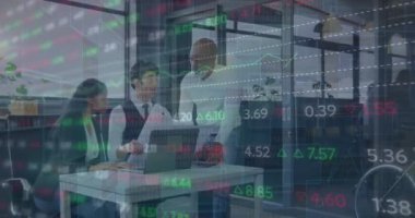 Animation of trading board and graphs over multiracial coworkers discussing scale drawing at office. Digital composite, multiple exposure, stock market, report, finance, teamwork and technology.