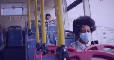Animation of data processing over african american woman wearing face mask and using smartphone. Global pandemic, communication and digital interface concept digitally generated video.