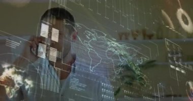 Animation of interface with data processing over caucasian man talking on smartphone at home. Computer interface and business technology concept