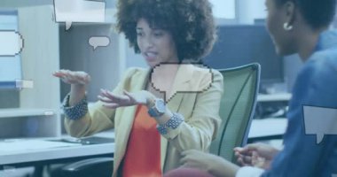 Animation of speech bubbles over diverse business people discussing work. Global business, finances and digital interface concept, digitally generated video.