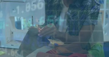 Animation of financial data processing over biracial man using graphic tablet. Global business, finance, computing and data processing concept digitally generated video.