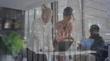 Animation of financial data processing over diverse business people discussing in office. Global business, finance, computing and data processing concept digitally generated video.