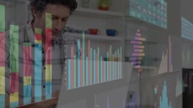 The man in the video is smiling and using a laptop at home, representing global business, finances, connections and digital interface concept. 