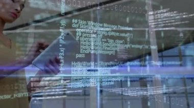 Animation of computer language, binary codes and lens flare over asian woman using digital tablet. Digital composite, multiple exposure, coding, machine learning, illuminated and technology concept.