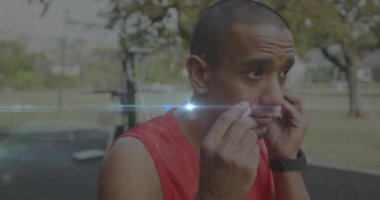 Animation of glowing light and connections over biracial man with earphones exercising. Sports, competition and data processing concept digitally generated video.