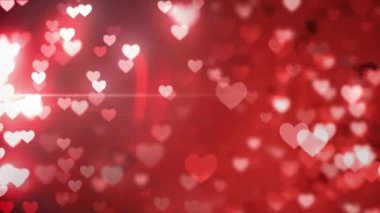 Animation of falling glowing red hearts over dark background. Valentines day celebration concept digital generated video.