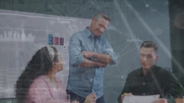 Animation of connected dots and icons, graph icons over diverse coworkers sharing ideas in office. Digital composite, multiple exposure, report finance, teamwork, communication and technology.