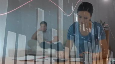 Animation of graphs and numbers over stressed caaucasian woman calculating bills at home. Digital composite, multiple exposure, report, home finance, banking and debt concept.