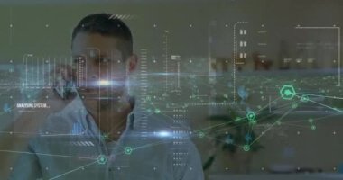 Animation of network of connections and network of icons over caucasian man talking on smartphone. Global networking and business technology concept