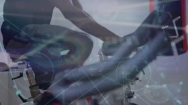 Animation of data processing over biracial man exercising on stationary bike. Global sports, exercise, computing and data processing concept digitally generated video.