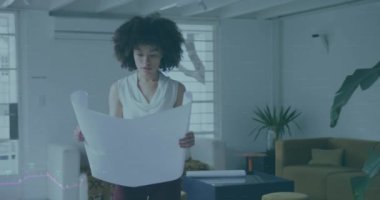 Animation of financial data processing over african american businesswoman working at office. Global business, finances and digital interface concept, digitally generated video.