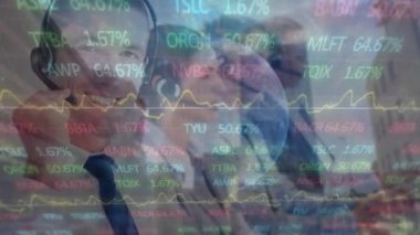 Animation of financial data processing over diverse business people using phone headsets in office. Global business, finance, computing and data processing concept digitally generated video.