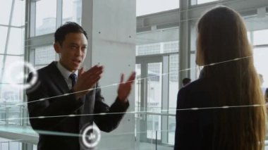 Animation of network of connections with icons over diverse business people working at office. Global business, connections and digital interface concept digitally generated video.