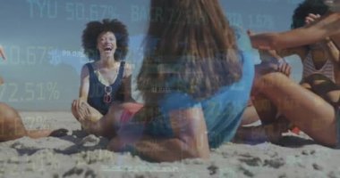 Animation of financial data processing over friends on beach. Global holiday, finance, computing, connections and data processing concept digitally generated video.