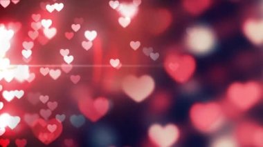 Animation of falling glowing red hearts over dark background. Valentines day celebration concept digital generated video.