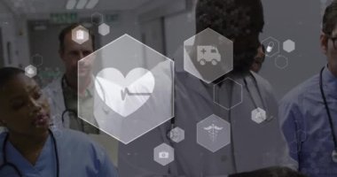 Animation of medical icons over team of diverse doctors and health workers discussing at hospital. Medical research and and healthcare technology concept