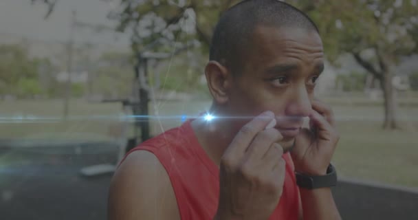 Animation Glowing Light Connections Biracial Man Earphones Exercising Sports Competition — Vídeo de Stock