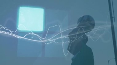 Animation of data processing over footballers. Global sports, networks, computing and data processing concept digitally generated video.