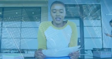 Animation of financial data processing over african american businesswoman. Global business, finance, computing and data processing concept digitally generated video.