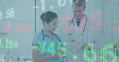 Animation of financial data processing over diverse male doctor and female health worker discussing. Global economy and medical healthcare technology concept