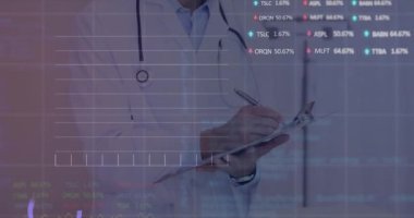 Animation of stock market data processing over biracial male doctor writing on clipboard at hospital. Global economy and medical healthcare technology concept