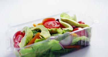 Video of 100 percent vegan text over box with fresh vegetables. Vegan food, fresh fruit and vegetables concept digitally generated video.