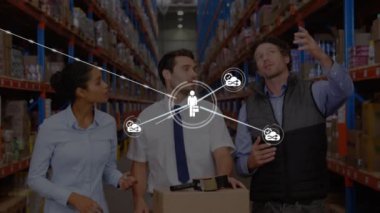 Animation of connected icons over caucasian coworkers discussing inventory in warehouse. Digital composite, multiple exposure, business, teamwork, distribution, logistics and shipping concept.