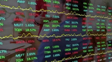 Animation of stock market data processing over male and female colleagues discussing at office. Global economy and business technology concept