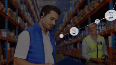 Animation of connected phone and music icons over caucasian male foremen working in warehouse. Digital composite, multiple exposure, teamwork, inspection, technology, logistics and shipping.
