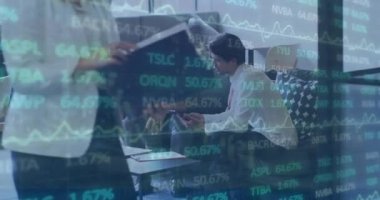 Animation of trading board moving over diverse male coworkers discussing plan over laptop in office. Digital composite, multiple exposure, stock market, teamwork, planning, business and technology.