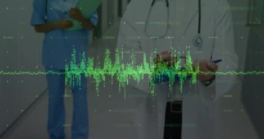 Animation of data processing over diverse male doctor and female health worker smiling at hospital. Medical healthcare and business data technology concept