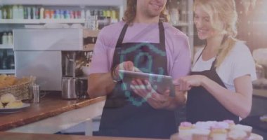 Animation of security padlock icon over caucasian waiter and waitress using digital tablet. Cyber security and medical healthcare technology concept