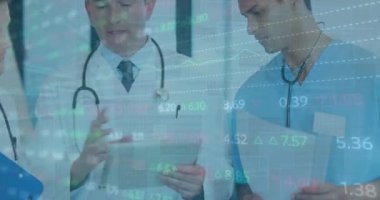 Animation of trading board and graphs over diverse senior doctor explaining coworkers over tablet. Digital composite, multiple exposure, medical, healthcare, investment, report, teamwork, technology.