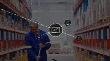 Animation of connected phone and laptop icons over caucasian man cleaning floor in warehouse. Digital composite, multiple exposure, technology, bucket, mop, logistics, shipping, occupation.