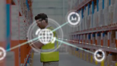 Animation of connected icons over caucasian man scanning boxes with bar code reader in warehouse. Digital composite, multiple exposure, network, bar graph, inventory, logistics and shipping concept.