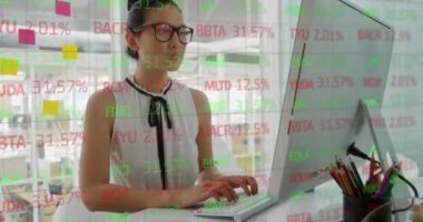 Animation of financial data processing over biracial businesswoman using computer. Global business, finances, computing and data processing concept digitally generated video.