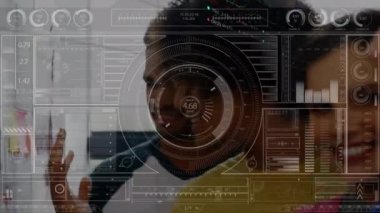 Animation of trading board, graphs and hud interface, multiracial coworkers sharing ideas in office. Digital composite, multiple exposure, progress, teamwork, shape, stock market, report, business.