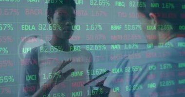 Animation of trading board over diverse woman explaining ideas to coworker over digital tablet. Digital composite, multiple exposure, stock market, business, office, teamwork and technology concept.