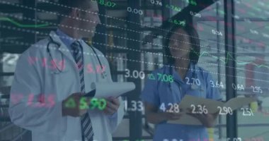 Animation of trading board and graphs over diverse doctors discussing medical reports in hospital. Digital composite, multiple exposure, medical, healthcare, teamwork, investment, finance, technology.