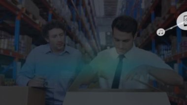 Animation of connected phone and music icons over caucasian managers inspecting boxes in warehouse. Digital composite, multiple exposure, technology, teamwork, logistics and shipping concept.