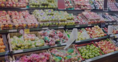 Animation of stock market data processing against fresh fruits on the shelves at a grocery store. Global economy and retail business technology concept