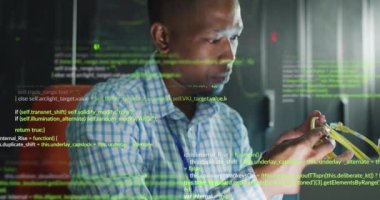 Animation of data processing over african american male it engineer and computer servers. Global computing and data processing concept digitally generated video.