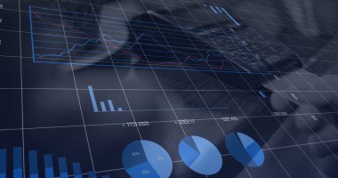 Composition of data processing over man paying with credit card over payment terminal. Global online shopping, business, finance, computing and data processing concept digitally generated image.