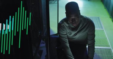 Animation of data processing over african american male it engineer and computer servers. Global computing and data processing concept digitally generated video.