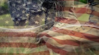 A composite of military boots while american flags waving in the background. Global business finances connections and digital interface concept digitally generated video.