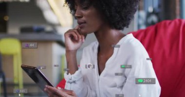 Animation of social media icons over african american businesswoman. Global social media, business, finances, computing and data processing concept digitally generated video.