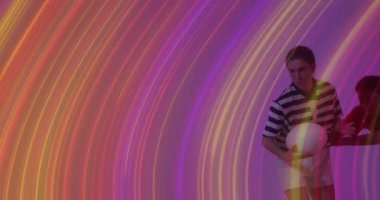 Animation of light trails over female rugby players on neon background. Sports and communication concept digitally generated video.