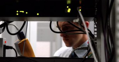 Animation of multiple social media icons against caucasian male engineer working at server room. Social media networking and business data storage technology concept