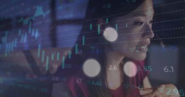 Animation of data processing over biracial businesswoman working in office. Global business, finances, computing and data processing concept digitally generated video.
